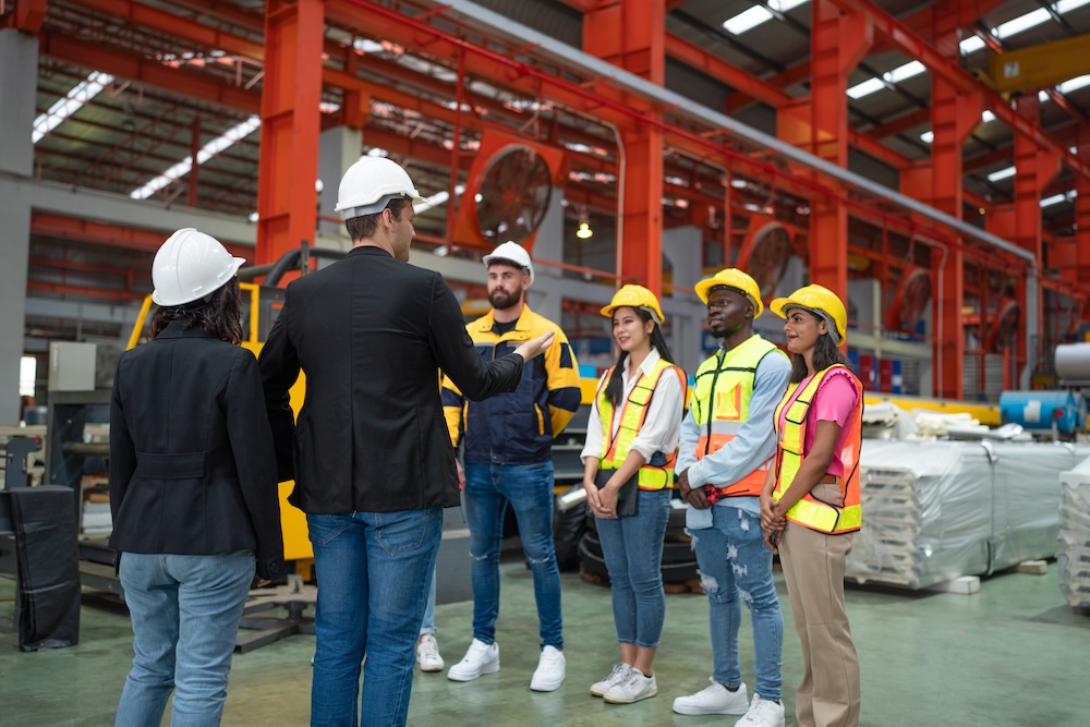 Portrait of Manager and team in modern industrial factory.